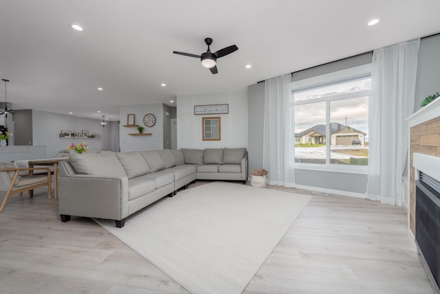 5125 N Ellie Ln, Spokane, WA 99217 - living area featuring a ceiling fan, a fireplace, recessed lighting, baseboards, and light wood-style flooring