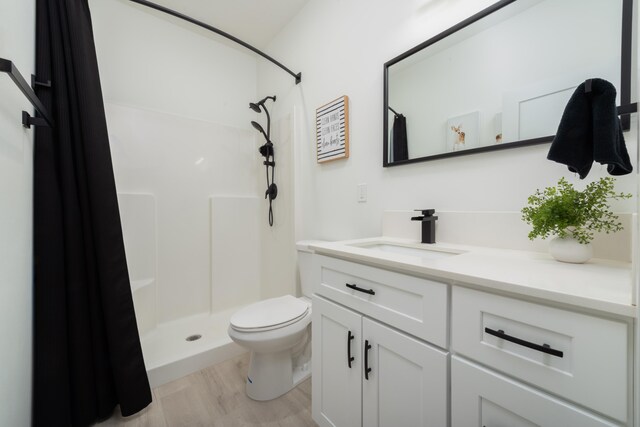 5125 N Ellie Ln, Spokane, WA 99217 - bathroom with vanity, wood finished floors, curtained shower, and toilet