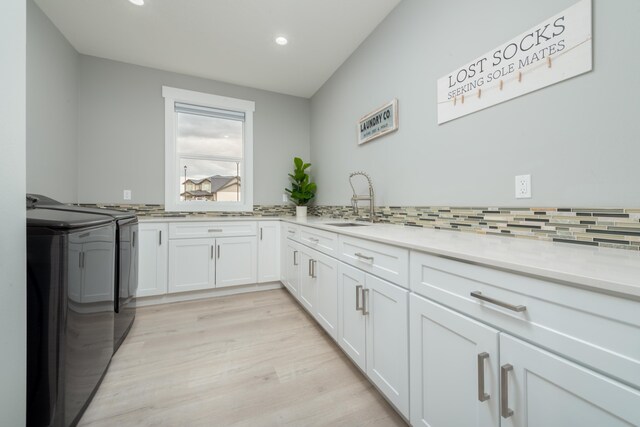 5125 N Ellie Ln, Spokane, WA 99217 - washroom with washing machine and dryer, cabinet space, recessed lighting, and light wood-type flooring