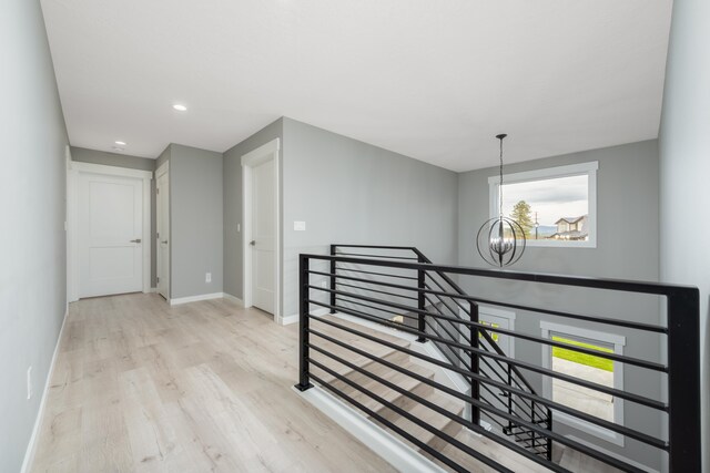 5125 N Ellie Ln, Spokane, WA 99217 - corridor featuring an upstairs landing, a chandelier, wood finished floors, healthy amount of natural light, and recessed lighting