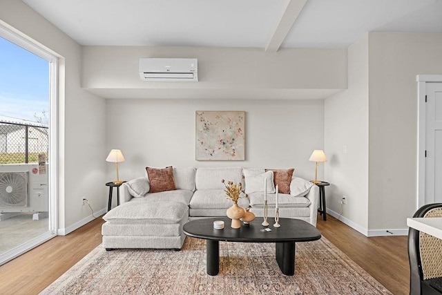 202 S Union Road Building B, Unit 102, Spokane, WA 99206 - living area featuring an AC wall unit, wood finished floors, baseboards, and beamed ceiling