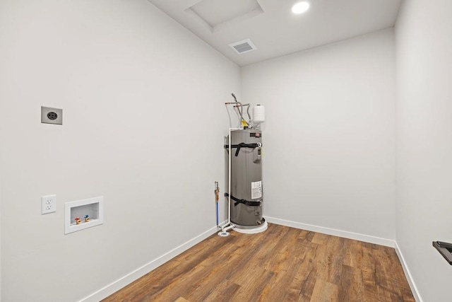 202 S Union Road Building B, Unit 102, Spokane, WA 99206 - laundry area with hookup for an electric dryer, water heater, hookup for a washing machine, wood finished floors, and baseboards