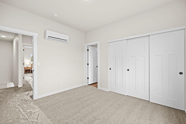 202 S Union Road Building B, Unit 102, Spokane, WA 99206 - unfurnished bedroom featuring an AC wall unit, carpet floors, a closet, and baseboards
