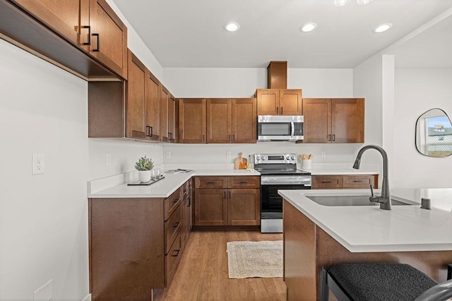 202 S Union Road Building B, Unit 102, Spokane, WA 99206 - kitchen with appliances with stainless steel finishes, light wood finished floors, a sink, light countertops, and recessed lighting