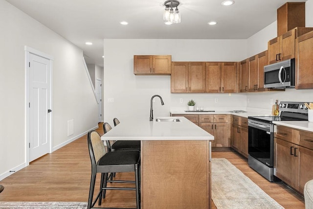 202 S Union Road Building B, Unit 102, Spokane, WA 99206 - kitchen with appliances with stainless steel finishes, a sink, light wood-type flooring, light countertops, and recessed lighting