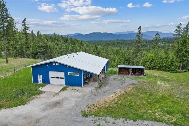 2559F United Copper Mine Rd, Chewelah, WA 99109 - view of pole building featuring a view of trees, a mountain view, and driveway