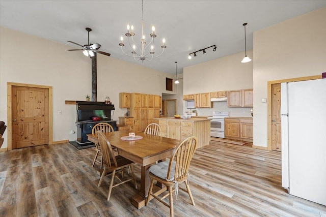 2559F United Copper Mine Rd, Chewelah, WA 99109 - dining room featuring a towering ceiling, light wood-style flooring, ceiling fan, track lighting, and a chandelier
