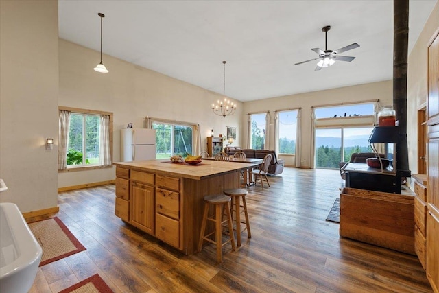 2559F United Copper Mine Rd, Chewelah, WA 99109 - kitchen featuring freestanding refrigerator, butcher block counters, dark wood-style flooring, a chandelier, and a ceiling fan
