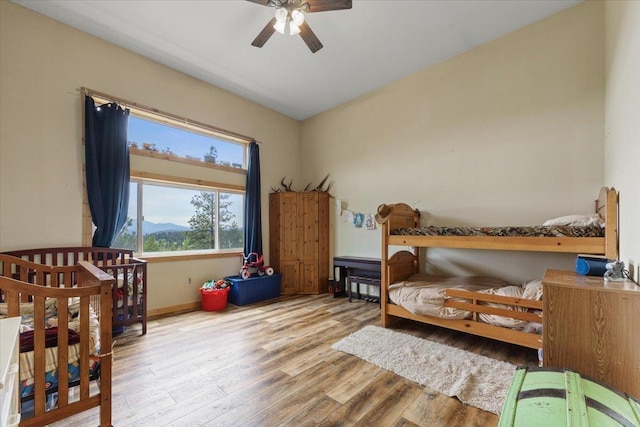 2559F United Copper Mine Rd, Chewelah, WA 99109 - bedroom featuring wood finished floors, baseboards, a ceiling fan, and a mountain view