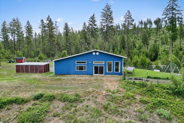 2559F United Copper Mine Rd, Chewelah, WA 99109 - back of house with a view of trees and an outbuilding
