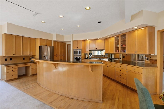 14410 E 45th Ct, Veradale, WA 99037 - kitchen with appliances with stainless steel finishes, a kitchen breakfast bar, light wood-style flooring, and recessed lighting
