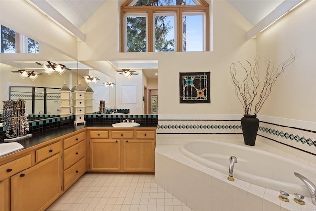 14410 E 45th Ct, Veradale, WA 99037 - bathroom with a garden tub, vanity, tile patterned floors, and high vaulted ceiling