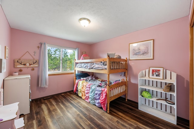 39810 N Hardesty Ln, Elk, WA 99009 - bedroom with wood finished floors, baseboards, and a textured ceiling