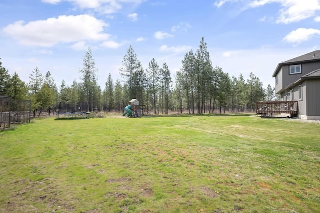 39810 N Hardesty Ln, Elk, WA 99009 - view of yard featuring a trampoline, a playground, and a wooden deck