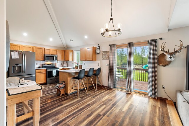 39810 N Hardesty Ln, Elk, WA 99009 - kitchen featuring appliances with stainless steel finishes, a peninsula, dark wood finished floors, light countertops, and a chandelier