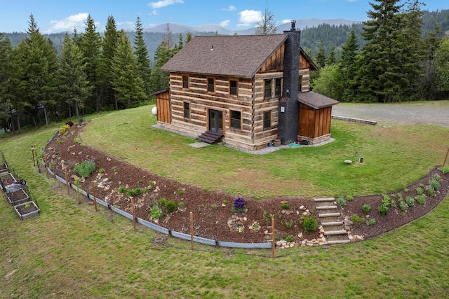 4165 S Varnum Pr, Coeur D Alene, ID 83814 - rear view of property with a chimney, entry steps, log siding, a view of trees, and a yard