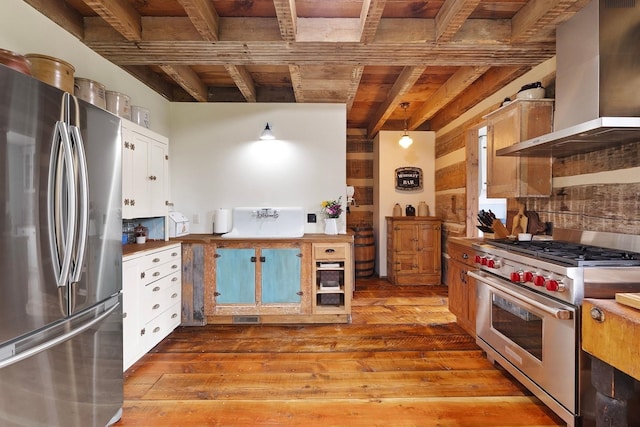 4165 S Varnum Pr, Coeur D Alene, ID 83814 - kitchen with appliances with stainless steel finishes, wall chimney range hood, wood ceiling with exposed beams, wood-type flooring, and a sink