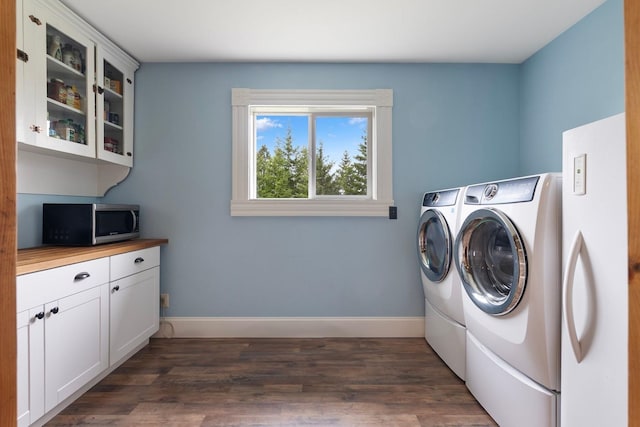 4165 S Varnum Pr, Coeur D Alene, ID 83814 - laundry room with washer and dryer, baseboards, cabinet space, and dark wood-type flooring