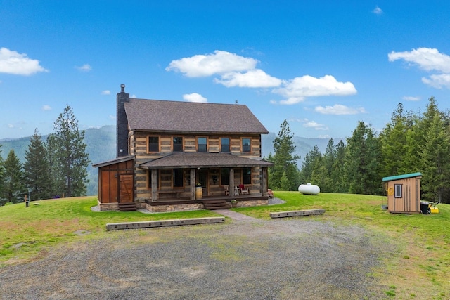 4165 S Varnum Pr, Coeur D Alene, ID 83814 - log home with a porch, a front yard, a chimney, and a mountain view