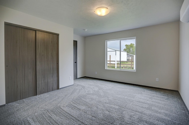 18509 E Michielli Ln, Spokane Valley, WA 99016 - unfurnished bedroom with light colored carpet, a closet, baseboards, and a textured ceiling