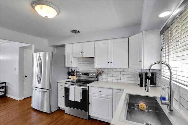 6914 N Jefferson St, Spokane, WA 99208 - kitchen featuring stainless steel appliances, a sink, white cabinets, light countertops, and tasteful backsplash