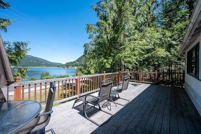 2948 Deep Lake Boundary Rd, Colville, WA 99114 - wooden terrace with outdoor dining area and a water and mountain view