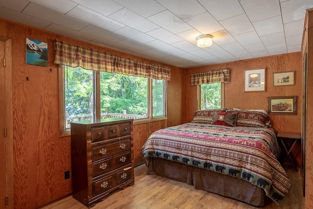 2948 Deep Lake Boundary Rd, Colville, WA 99114 - bedroom featuring wooden walls and light wood-style flooring