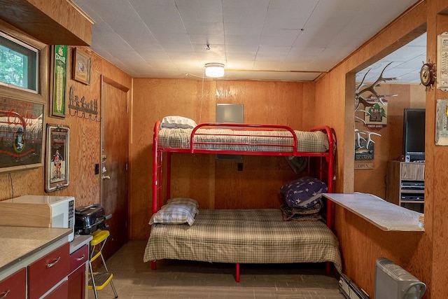 2948 Deep Lake Boundary Rd, Colville, WA 99114 - bedroom featuring wood walls and radiator heating unit