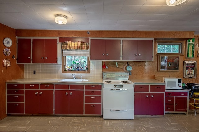 2948 Deep Lake Boundary Rd, Colville, WA 99114 - kitchen with red cabinetry, white appliances, a sink, and tile patterned floors
