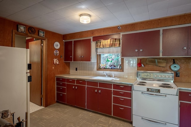 2948 Deep Lake Boundary Rd, Colville, WA 99114 - kitchen with white appliances, a sink, red cabinetry, light countertops, and decorative backsplash