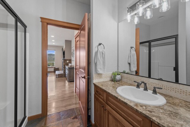 6595D Lois Way, Nine Mile Falls, WA 99026 - full bathroom with a shower stall, vanity, stone finish floors, tasteful backsplash, and recessed lighting