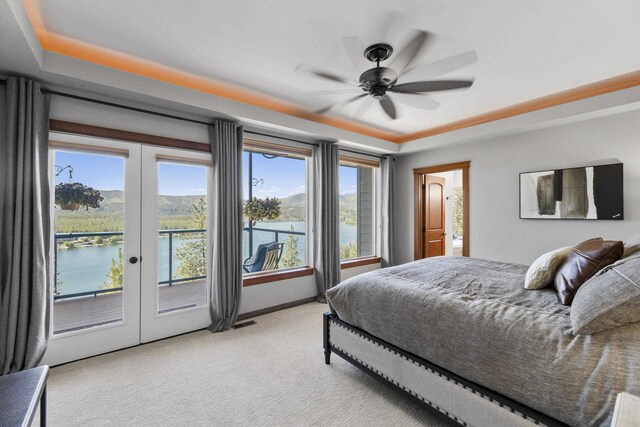 6595D Lois Way, Nine Mile Falls, WA 99026 - bedroom with access to exterior, french doors, a raised ceiling, and light carpet