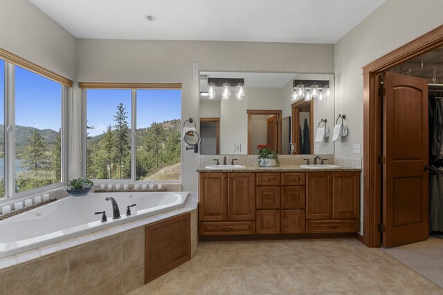 6595D Lois Way, Nine Mile Falls, WA 99026 - full bathroom featuring double vanity, a bath, tile patterned flooring, and a closet