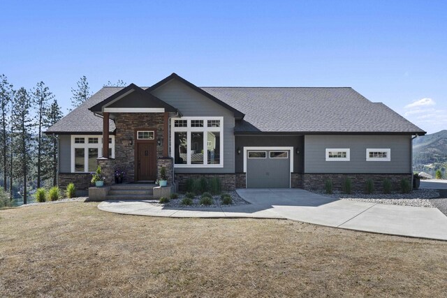 6595D Lois Way, Nine Mile Falls, WA 99026 - craftsman inspired home with stone siding, a garage, driveway, and a shingled roof
