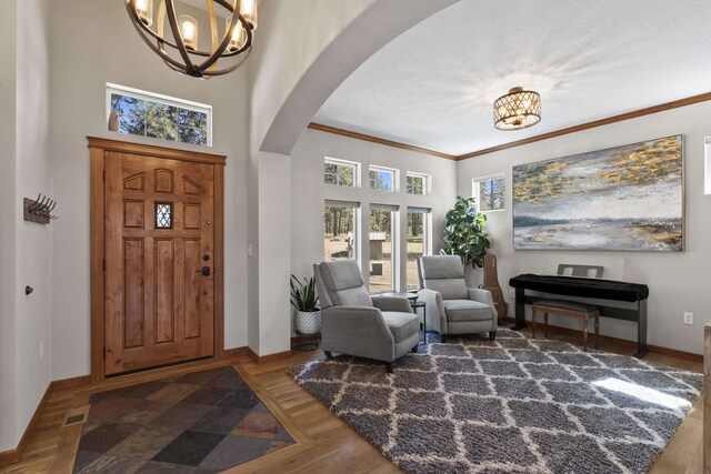 6595D Lois Way, Nine Mile Falls, WA 99026 - foyer featuring a chandelier, arched walkways, baseboards, a high ceiling, and crown molding