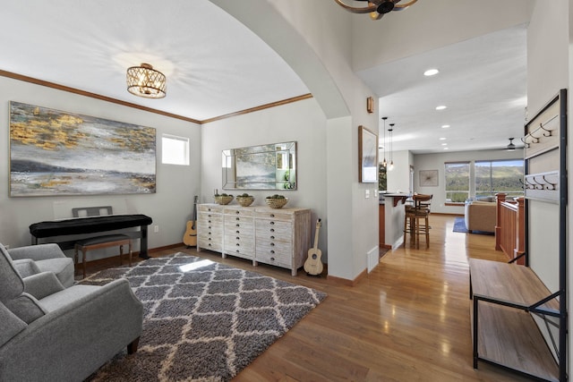 6595D Lois Way, Nine Mile Falls, WA 99026 - living room featuring arched walkways, baseboards, wood finished floors, recessed lighting, and ornamental molding