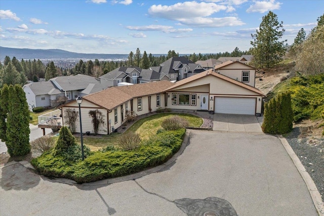8626 E Sugar Pine Ln, Spokane, WA 99217 - view of front of house with a garage, concrete driveway, and a residential view