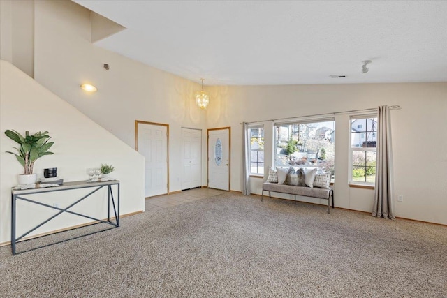 8626 E Sugar Pine Ln, Spokane, WA 99217 - foyer entrance featuring carpet, a chandelier, baseboards, and high vaulted ceiling