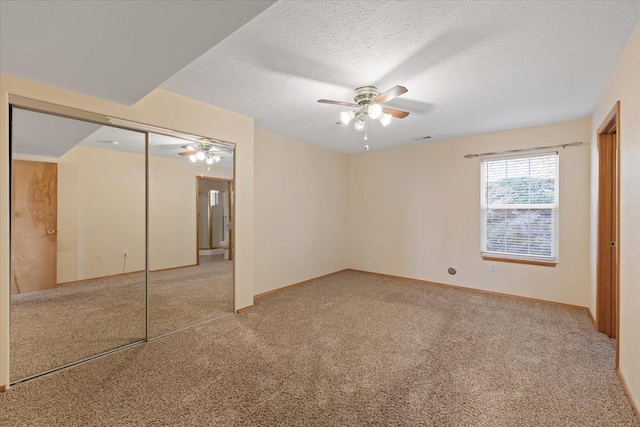 8626 E Sugar Pine Ln, Spokane, WA 99217 - unfurnished bedroom with carpet floors, a closet, a textured ceiling, baseboards, and a ceiling fan