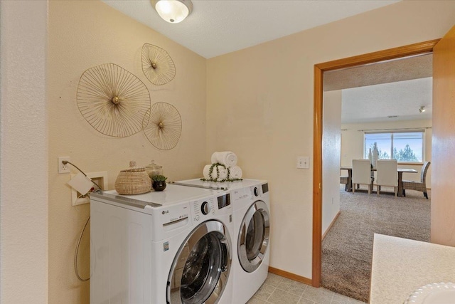 8626 E Sugar Pine Ln, Spokane, WA 99217 - laundry area with washing machine and clothes dryer, light colored carpet, and baseboards
