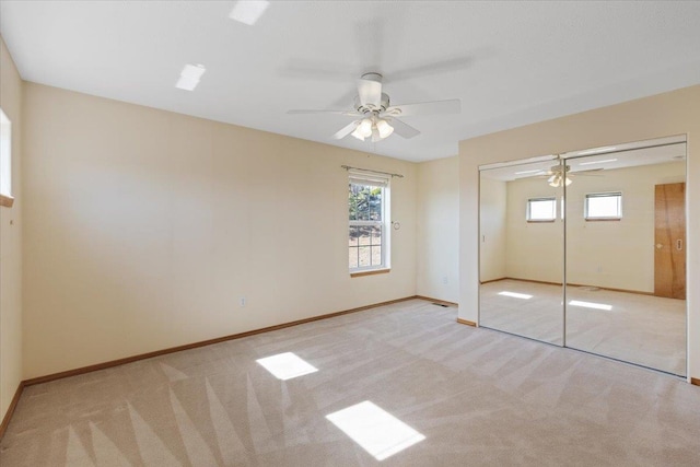 8626 E Sugar Pine Ln, Spokane, WA 99217 - unfurnished bedroom with multiple windows, carpet floors, baseboards, and a closet
