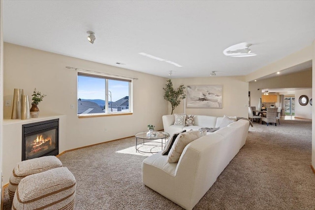 8626 E Sugar Pine Ln, Spokane, WA 99217 - carpeted living area with a glass covered fireplace and baseboards