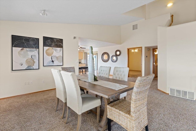 8626 E Sugar Pine Ln, Spokane, WA 99217 - carpeted dining room featuring baseboards and lofted ceiling