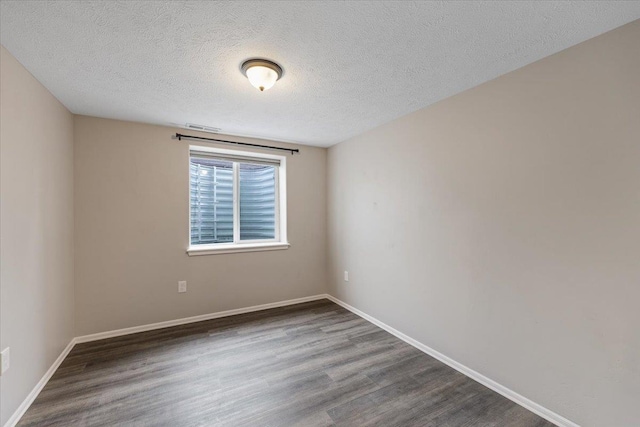 10 S Greenacres Ave, Spokane Valley, WA 99016 - empty room featuring wood finished floors, a textured ceiling, and baseboards