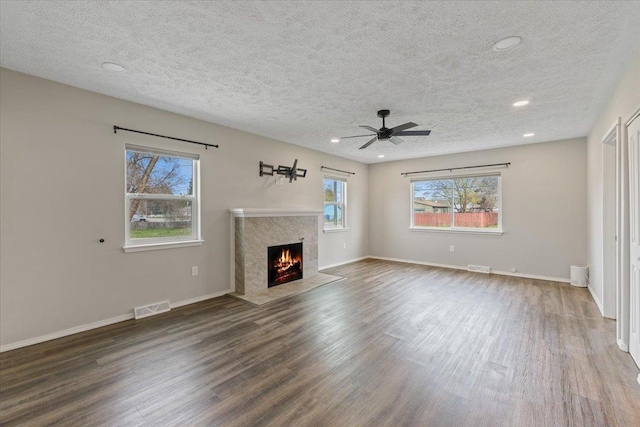 10 S Greenacres Ave, Spokane Valley, WA 99016 - unfurnished living room featuring a textured ceiling, wood finished floors, a high end fireplace, recessed lighting, and a ceiling fan
