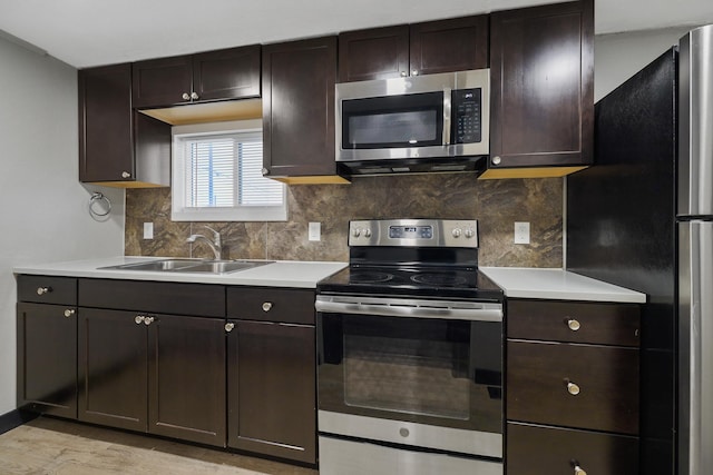 10 S Greenacres Ave, Spokane Valley, WA 99016 - kitchen featuring stainless steel appliances, light countertops, tasteful backsplash, and dark brown cabinetry