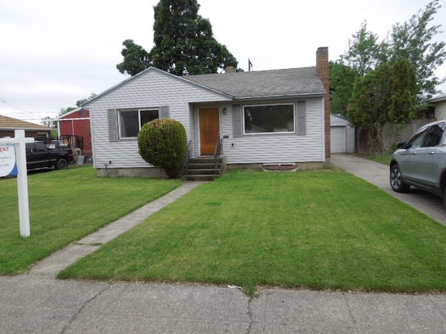 40 E Heroy Ave, Spokane, WA 99207 - view of front of home with an outbuilding, a chimney, a front yard, a garage, and entry steps