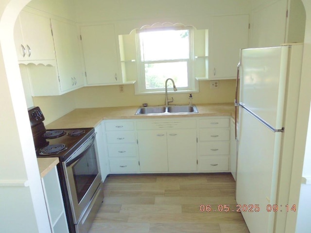 40 E Heroy Ave, Spokane, WA 99207 - kitchen featuring freestanding refrigerator, electric range, a sink, light countertops, and light wood-style flooring