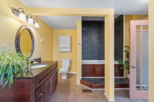 697 N Hofstetter St, Colville, WA 99114 - bathroom featuring vanity, toilet, shower / bathtub combination, baseboards, and tile patterned flooring