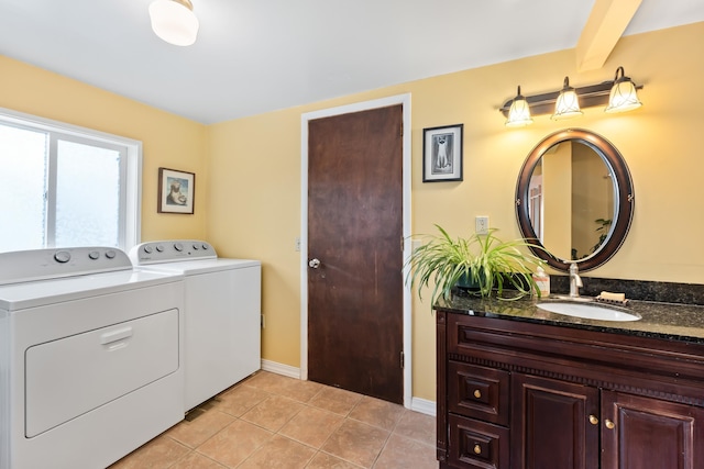 697 N Hofstetter St, Colville, WA 99114 - laundry room with washing machine and dryer, light tile patterned floors, and baseboards
